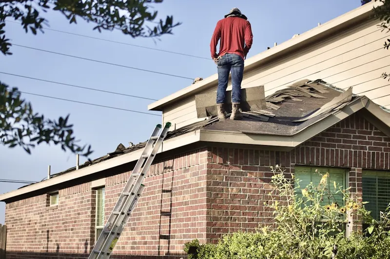 Professional roofer working on a residential roof in Wyncroft